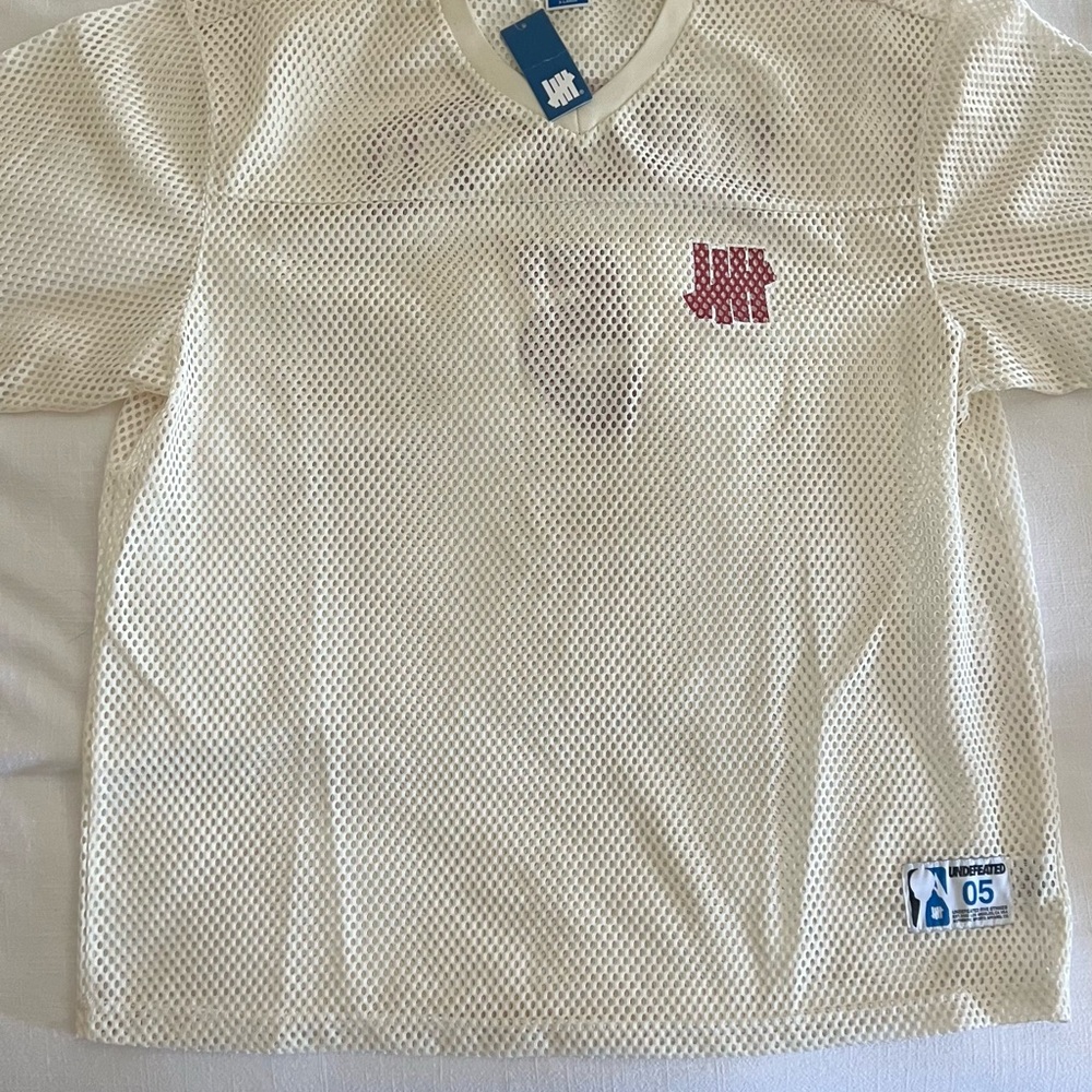 Undefeated Off-White Mesh Tee with Red Logo